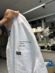 An image of A graduate student holding a Wake Forest lab coat